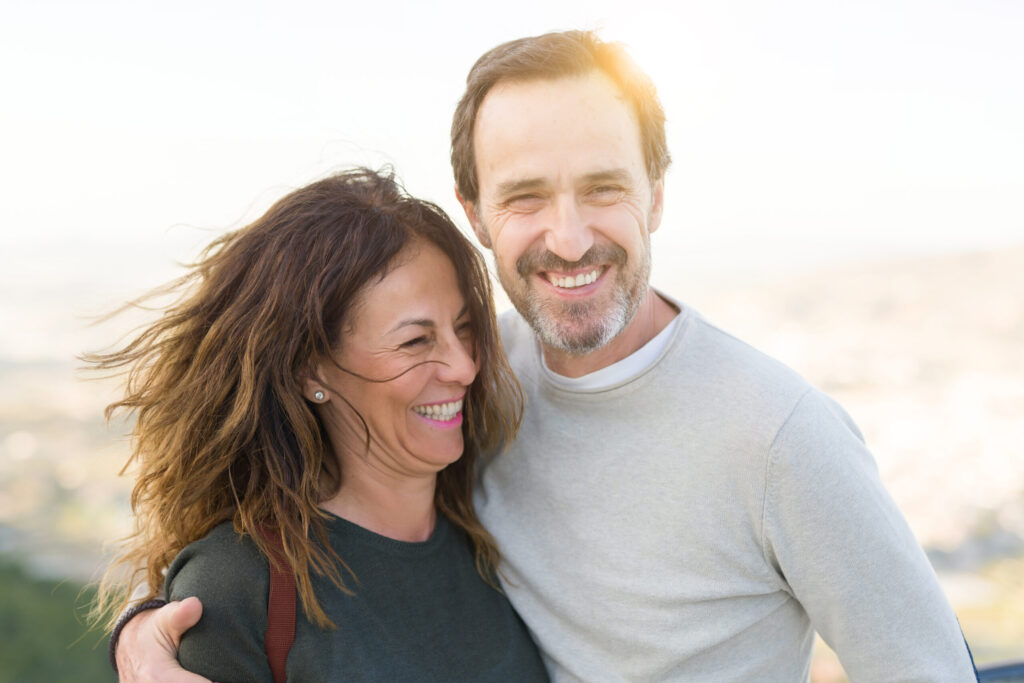 NHS Dentist - middle aged couple smiling and embracing