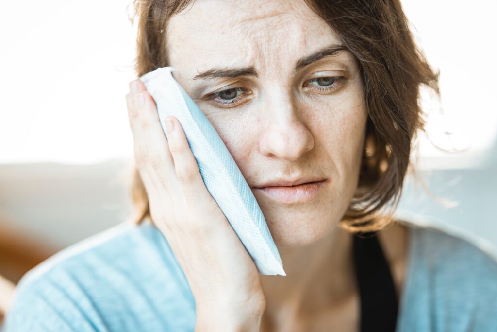 Root Canal Treatment Bayswater - Woman holding compress to toothache
