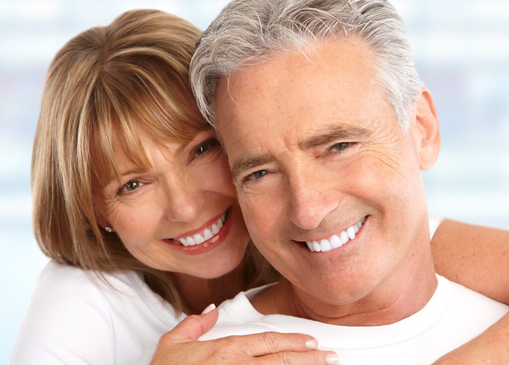 Middle aged couple smiling and embracing