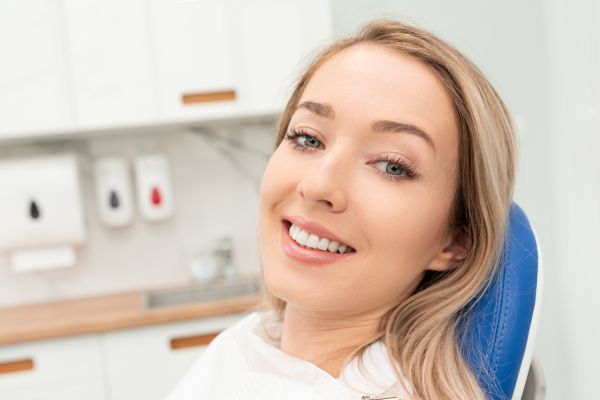 Dental Hygiene - Woman patient sitting in a dental chair, smiling